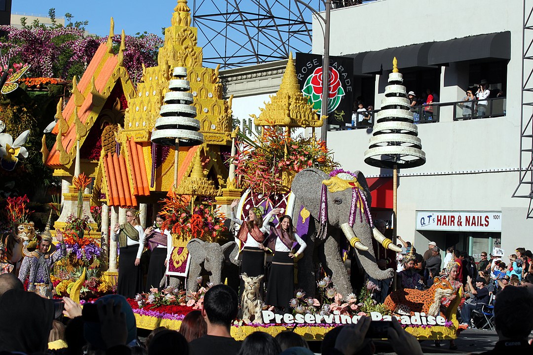 Thailand themed parade with elephant and tiger and waving people